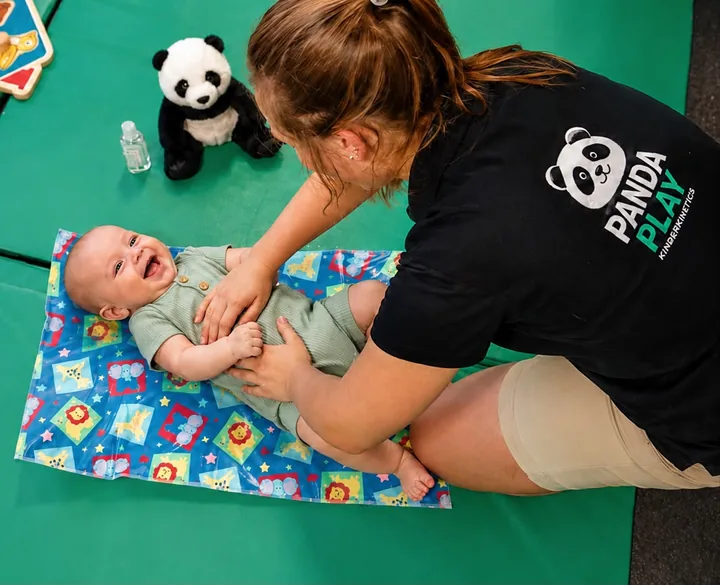 A smiling baby taking part in a Panda Play development session