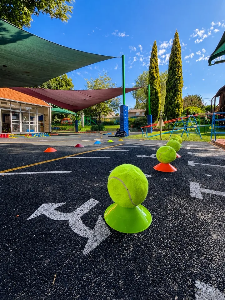 An outdoor sports development course with tennis balls and movement markers